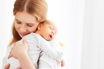 Wall Mural - newborn baby in tender embrace of mother