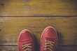 Red shoes on yellow wooden floor