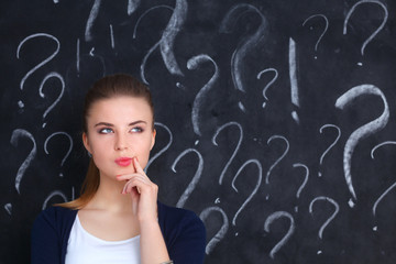 Young girl with question mark on a gray background