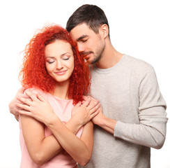 Poster - Happy young couple in love embracing, isolated on white