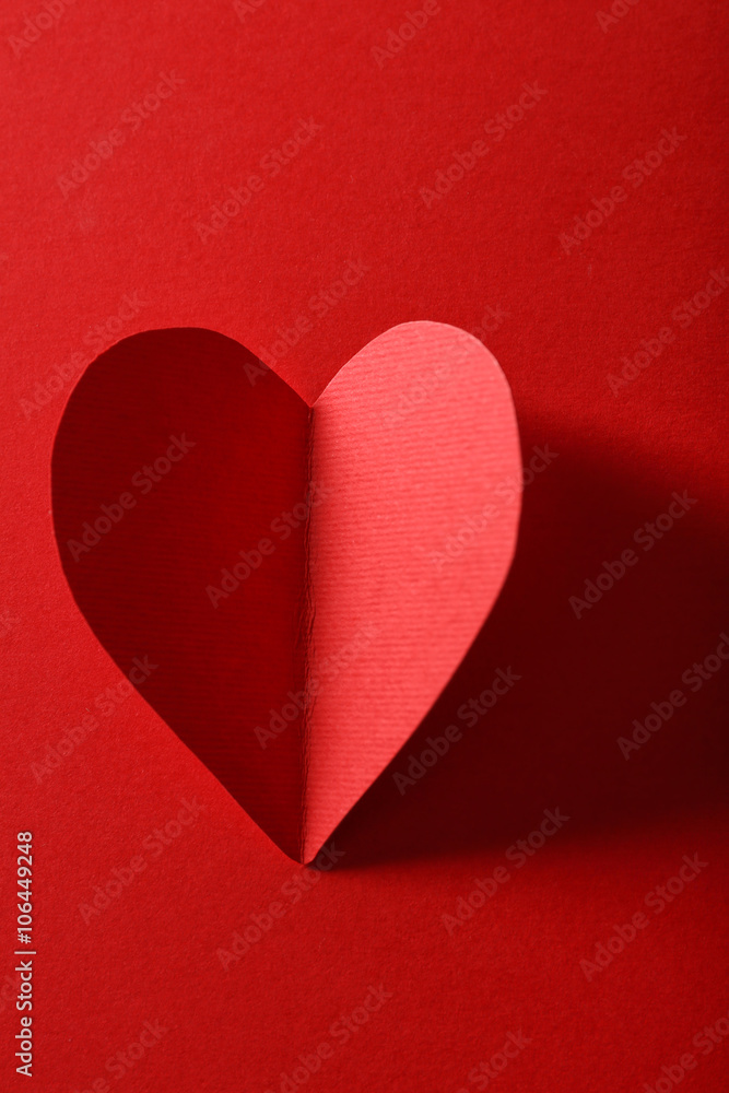 Beautiful paper heart on dark red background