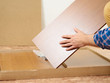 © volkovslava - Man opens box with furniture