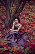 © kharchenkoirina - Lady in a luxury lush purple dress sits near the tree,fantastic shot,fairytale princess is walking in the autumn forest,fashionable toning,creative computer colors