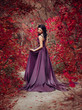 © kharchenkoirina - Lady in a luxury lush purple dress swirls in the smoke,fantastic shot,fairytale princess is walking in the autumn forest,fashionable toning,creative computer colors