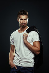 Portrait of handsome man in a studio on a dark background