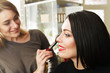 © lokisurina - makeup artist work. beauty saloon. beautiful brunette girl and makeup artist