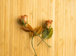 Fake flowers on the wooden floor