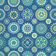 Seamless pattern of bright colorful geometric round ethnic decorative elements. Vector mandala background with bohemian, Oriental, Indian, Arabic, Aztec motifs.