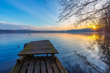 Wall Mural - Sunrise over lake at end of winter