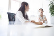 © Monet - Young women have a discussion in a stylish office
