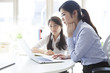 © Monet - Two business women looking at a laptop together