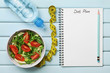 Diet plan, menu or program, tape measure, water and diet food of fresh salad on blue background, weight loss and detox concept, top view