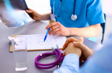 doctor with stethoscope on the patient's admission at the table