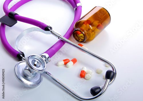 Fotografering Pills ,tablets and stethoscope on white background