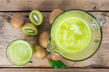 Wall Mural - Fresh kiwi juice with mint on wooden background