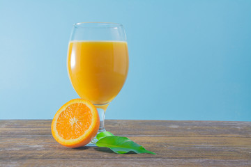 Wall Mural - Fresh orange juice with mint on wooden background