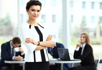 Wall Mural - Face of beautiful woman on background of business people