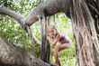 © Sollina Images/Blend Images - Caucasian girl climbing tropical tree