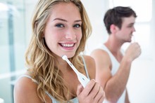 Young Couple Brushing Their Teeth At Home 