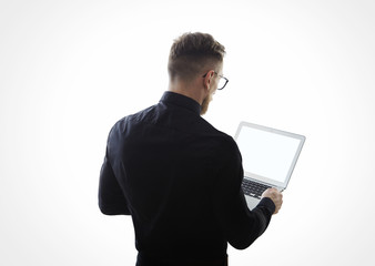 Wall Mural - Photo of young bearded businessman wearing black shirt and holding contemporary notebook hands. White empty screen ready for you message. Isolated white background. Horizontal mockup 