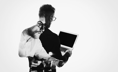 Double exposure young bearded  banker wearing black shirt and holding contemporary notebook hands.Blank screen ready for you message.Isolated white,portrait man background.Horizontal mockup 