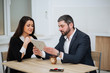 © ostap_davydiak - Happy Businesswoman Shaking Hands With Businessman In Office