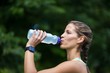 © WavebreakmediaMicro - Marathon female athlete running drinking water