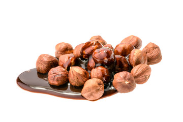 Wall Mural - Hazelnuts and chocolate syrup isolated on white