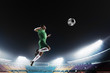 © xixinxing - Athlete heading soccer ball in stadium