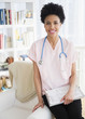 © JGI/Jamie Grill/Blend Images - Black nurse smiling at home visit