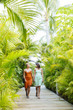 © Inti St Clair/Blend Images - Lesbian couple holding hands on tropical walkway