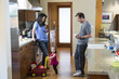 © Sam Diephuis/Blend Images - Family relaxing in kitchen