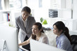 © Monet - Three business women looking at the desktop