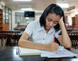 © gastuner - young woman student reading a book with stress