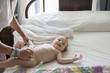© Marc Romanelli/Blend Images - Caucasian woman changing toddler's diaper