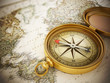 Vintage compass standing on old map