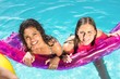 © WavebreakmediaMicro - Happy friends enjoying in the swimming pool