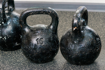 Round heavy weights on the floor in the gym closeup