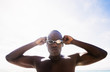 © JGI/Daniel Grill/Blend Images - Mixed race swimmer putting on goggles