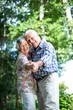© WavebreakMediaMicro - Portrait of senior couple dancing against trees