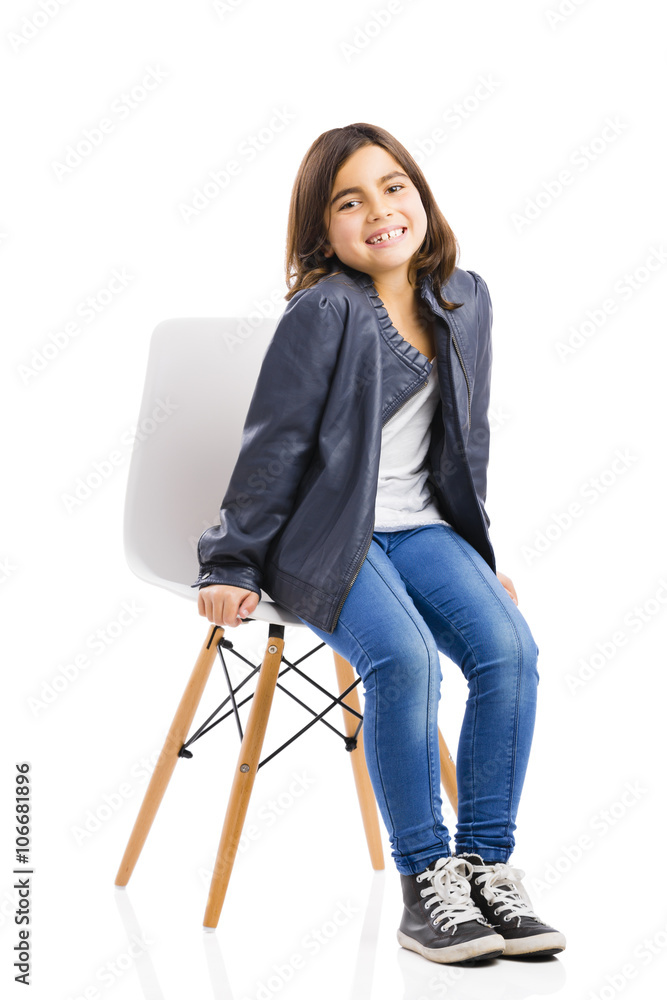 Beautiful young girl sitting on a chair Stock Photo | Adobe Stock