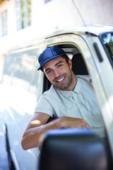 Smiling delivery person sitting in van