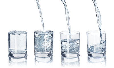 Wall Mural - a set of glasses with water on an isolated white background