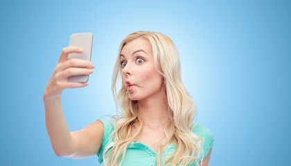 Canvas Print - funny young woman taking selfie with smartphone