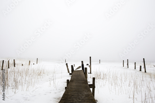 Pier in fog in the winter