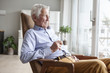 © Westend61 - Portrait of senior man sitting on armchair at home