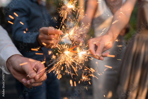 Fotografia Hands of people holding Bengal light at the party