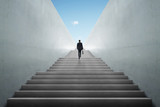 Fototapeta Sawanna - Ambitions concept with businessman climbing stairs