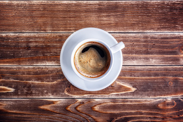 Wall Mural - cup of coffee on the wooden table