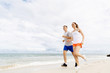 © Sergey Nivens - Runners. Young couple running on beach